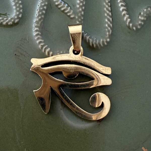 Oeil d'Horus pendentif en acier doré inoxydable 2.5 cm. Boutique La Porte des Secrets
